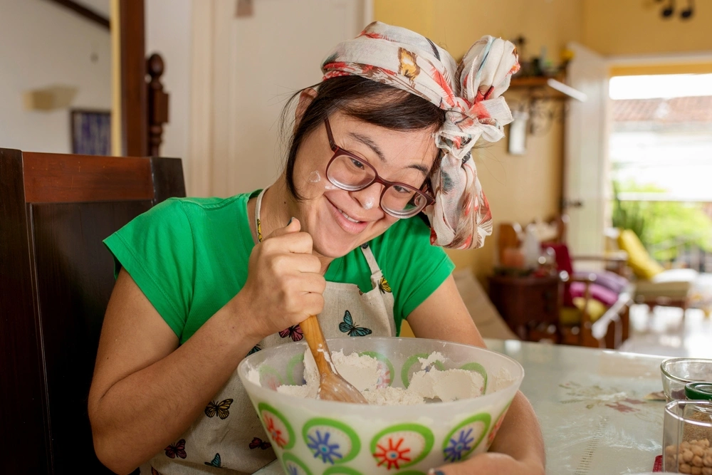 young girl with down syndrome disability baking