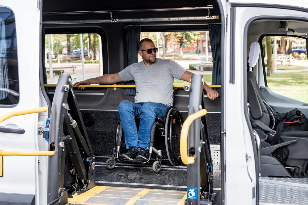 man on wheel chair and disability travelling in a special vehicle
