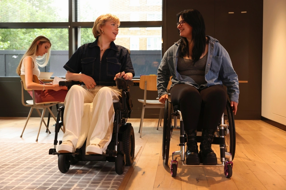 two women on wheel chair talking with each other