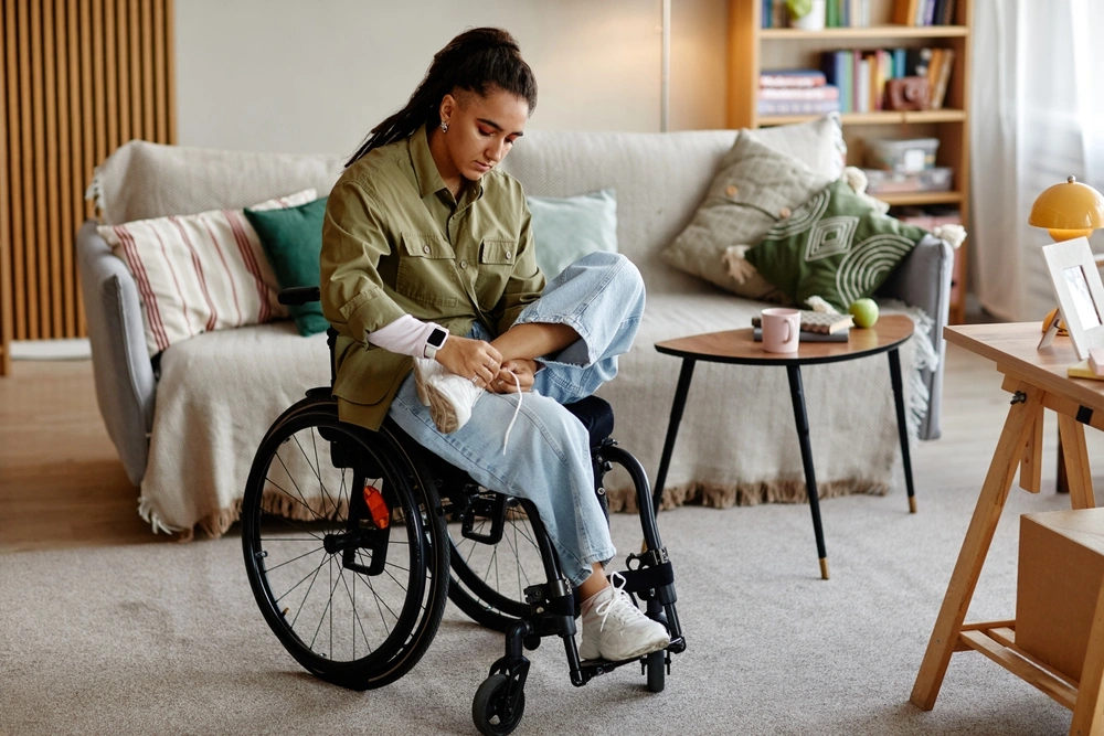 women in wheel chair looking at her feet